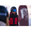 Person in Skibekleidung und Helm mit Skibrille im Schnee