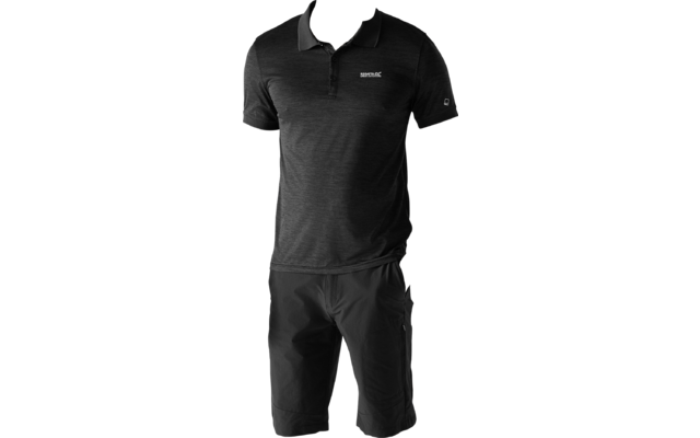 A standing man wearing a black polo shirt, black knee-length shorts, and black sneakers on a light background