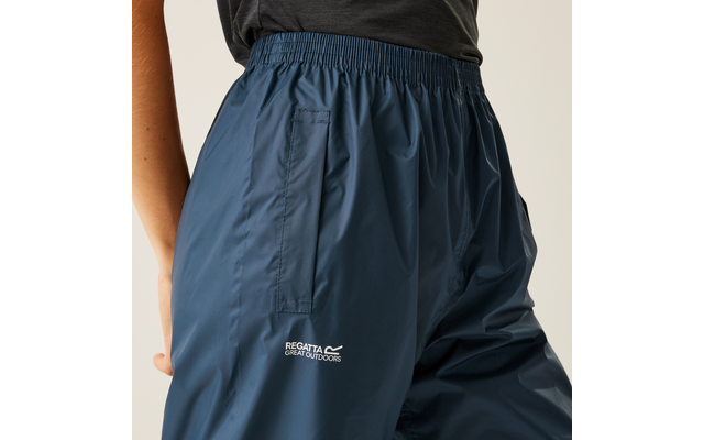 Waist to upper thighs of a person wearing dark blue pants made of smooth, slightly shiny fabric with elastic waistband, side pocket, and white 'REGATTA GREAT OUTDOORS' logo