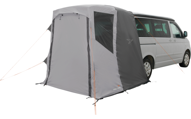 Graues Zelt an der Seite eines weißen Kleinbusses, mit seitlichem Fenster, orangefarbenen Abspannleinen und offenem Eingang