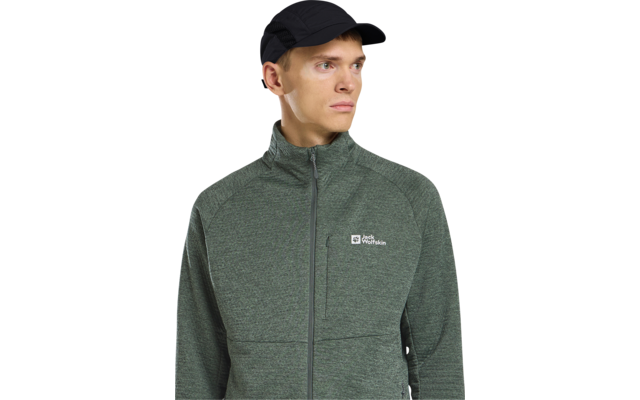 Person mit schwarzer Kappe und grüner, durchgezippten Jacke mit Jack Wolfskin-Logo, Blick nach rechts