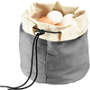 Gray fabric drawstring pouch with folded light rim holding white and brown eggs, black cord with stopper