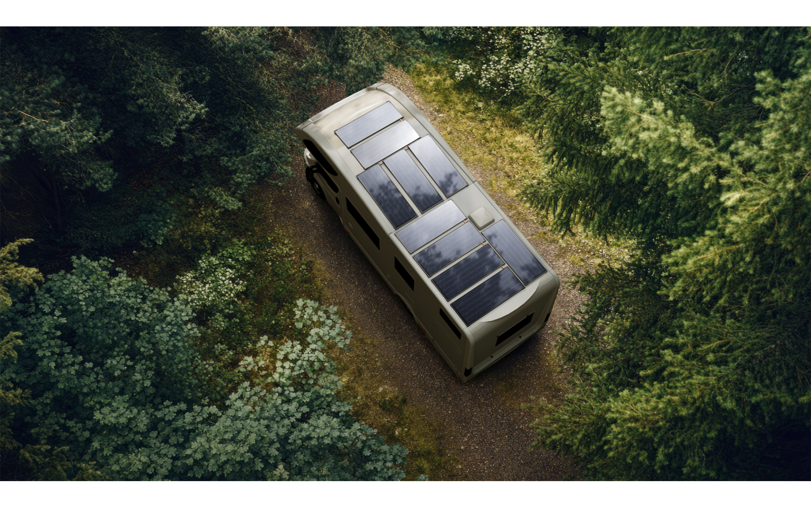 Wohnmobil mit Solarpanelen auf dem Dach fährt auf einem Waldweg