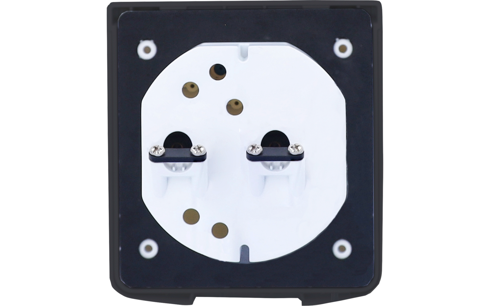 Schwarzer quadratischer Rahmen mit weißer runder Platte, zwei weiße zylindrische Einsätze jeweils mit silbernen Schrauben, mehrere kleine runde Metallöffnungen (gold- und dunkelfarben) auf der Platte, vier sichtbare Schrauben an den Rahmenecken