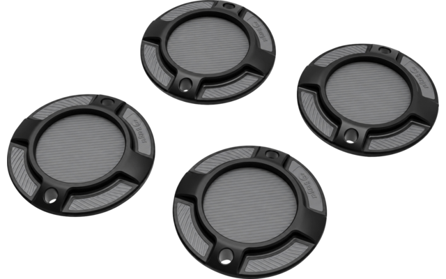 Quatre disques ronds noirs avec un centre gris rainuré, une bague extérieure à trois segments encastrés et une petite ouverture ronde, sur fond transparent