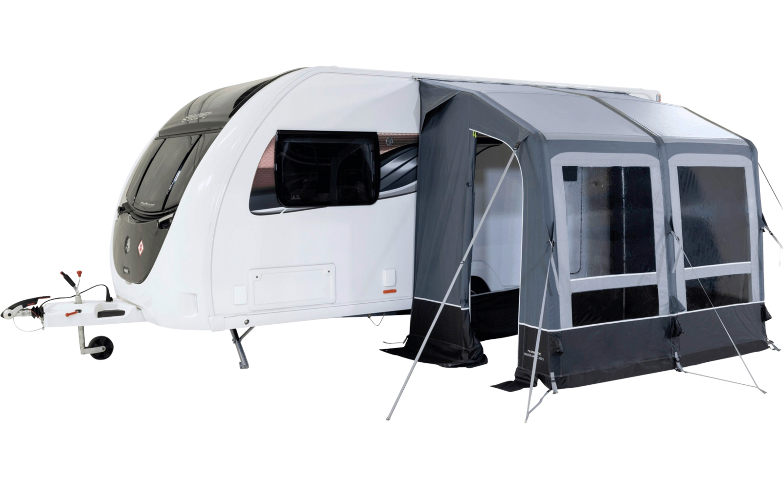 Roulotte bianca con veranda grigia, finestre visibili, ingresso aperto e gancio di traino