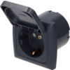 Dark gray recessed electrical outlet with open hinged cover, square frame and round socket opening with visible metal contacts, photographed from a slight front angle