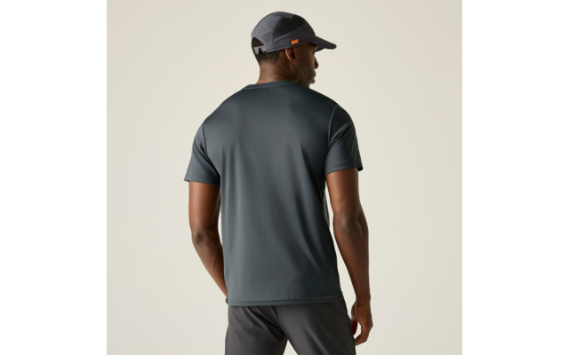 Person von hinten, trägt dunkelgraues kurzärmeliges T-Shirt, dunkle Shorts und graue Baseballkappe, heller einfarbiger Hintergrund