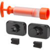 Orange plastic hand pump with T-shaped handle and transparent cylinder, two black rounded rectangular modules each with a circular protrusion, and two small black rectangular adapters with notches
