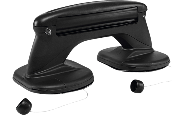 Dispositivo in plastica nera con due ventose rotonde collegate da un manico orizzontale; due piccoli tappi rotondi fissati con sottili cordini accanto alle ventose