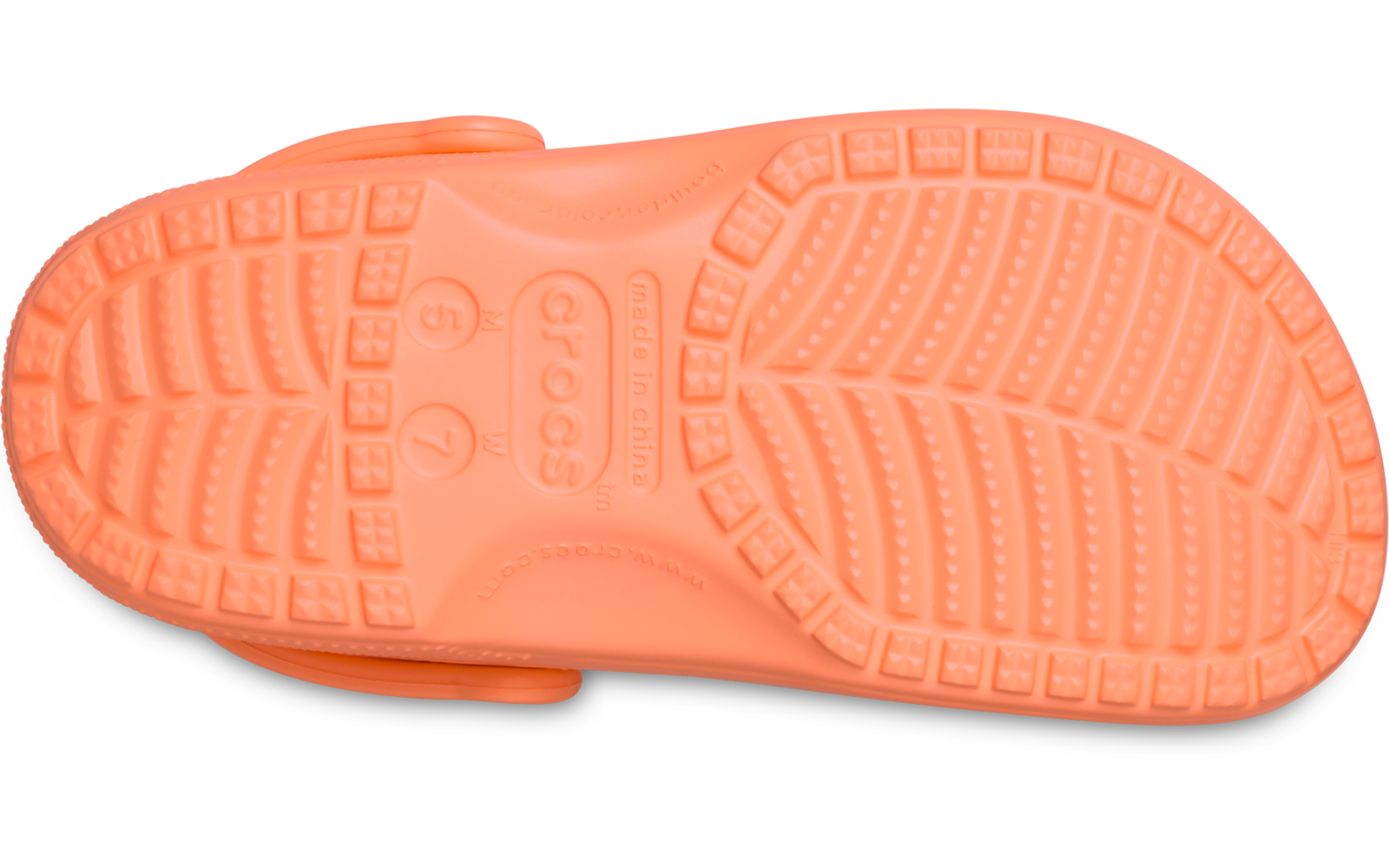 Unterseite einer orangefarbenen Gummischuhsohle mit Profilnoppen, sichtbarem Riemenansatz und eingeprägtem Schriftzug Crocs, auf weißem Hintergrund