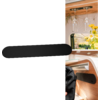Wood-paneled interior with window, hanging wine glasses, yellow flowers in a vase, long black object attached to the wall, black backpack on a wooden shelf