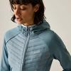 Person with short dark hair looking down, wearing light blue quilted jacket with hood, zipper and small chest logo