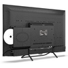 Achteraanzicht van een zwarte flatscreen-tv op twee pootjes, met ventilatieopeningen, aangesloten kabels, een zilveren schijf (cd/dvd) half ingestoken aan de zijkant en een rij aansluitingen onderaan