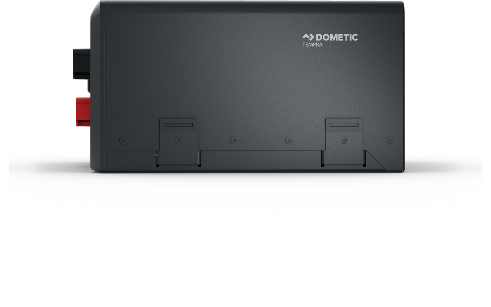 Boîtier rectangulaire gris foncé avec le logo « Dometic » en haut, deux bornes de connexion à gauche (rouge et noir) et deux trappes sur la partie inférieure avant