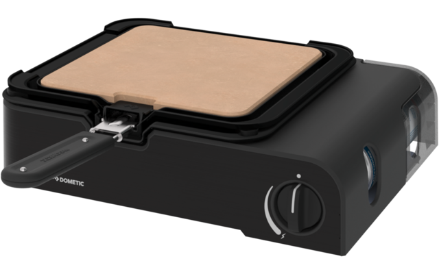 Schwarzer rechteckiger Korpus mit quadratischer hellbrauner Platte in einem schwarzen Rahmen, metallischer Griff vorne, runder Drehknopf rechts vorn und kleines "DOMETIC"-Logo auf der Vorderseite