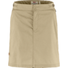 Beige skirt with central front seam, concealed front placket with two snap buttons at the waistband, belt loops and small round patch at lower left