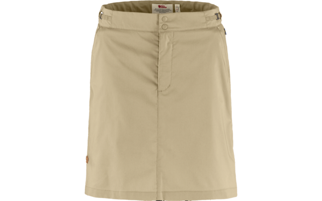 Beige skirt with central front seam, concealed front placket with two snap buttons at the waistband, belt loops and small round patch at lower left