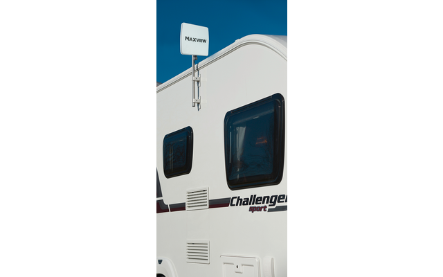 Weiße Seitenwand eines Wohnmobils mit zwei dunklen Fenstern, montierter Antenne mit 'Maxview'-Logo und Schriftzug 'Challenger sport', blauer Himmel