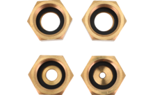 Quatre anneaux métalliques hexagonaux couleur or avec anneaux intérieurs noirs et ouvertures centrales de tailles différentes, disposés en deux rangées de deux sur fond blanc