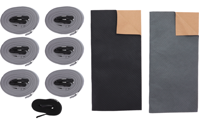 Six light-gray rolled straps with black buckles in two columns, a separate black looped strap, and two rectangular mats (black and dark gray), each with a tan folded top-right corner