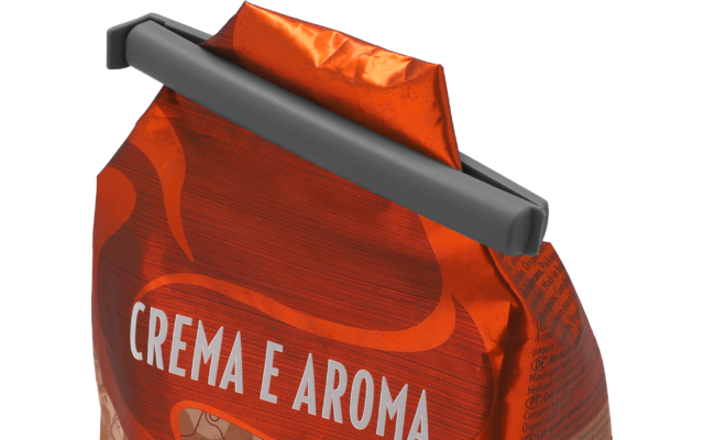 Rote, glänzende Verpackungstüte mit weißem Schriftzug CREMA E AROMA und grauem Clip oben; Falten und kleine Druckschrift an der Seite sichtbar