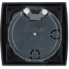 Black square frame with a round plastic cover stamped '230V-AC' and 'ABS'; two Phillips screws at the top; hinge and latch openings visible