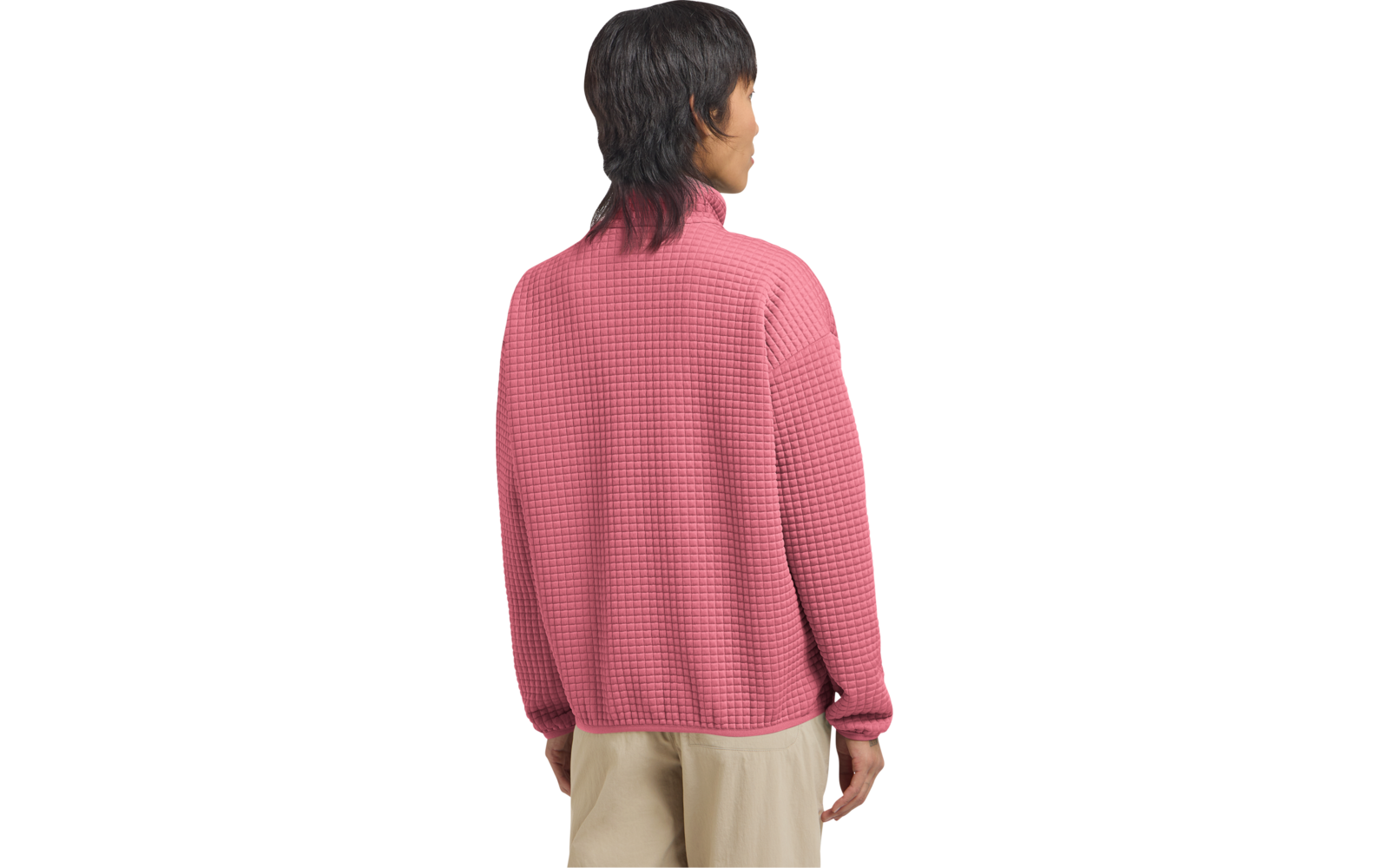 Person von hinten mit dunklen schulterlangen Haaren, rosa strukturierter Pullover und beige Hose