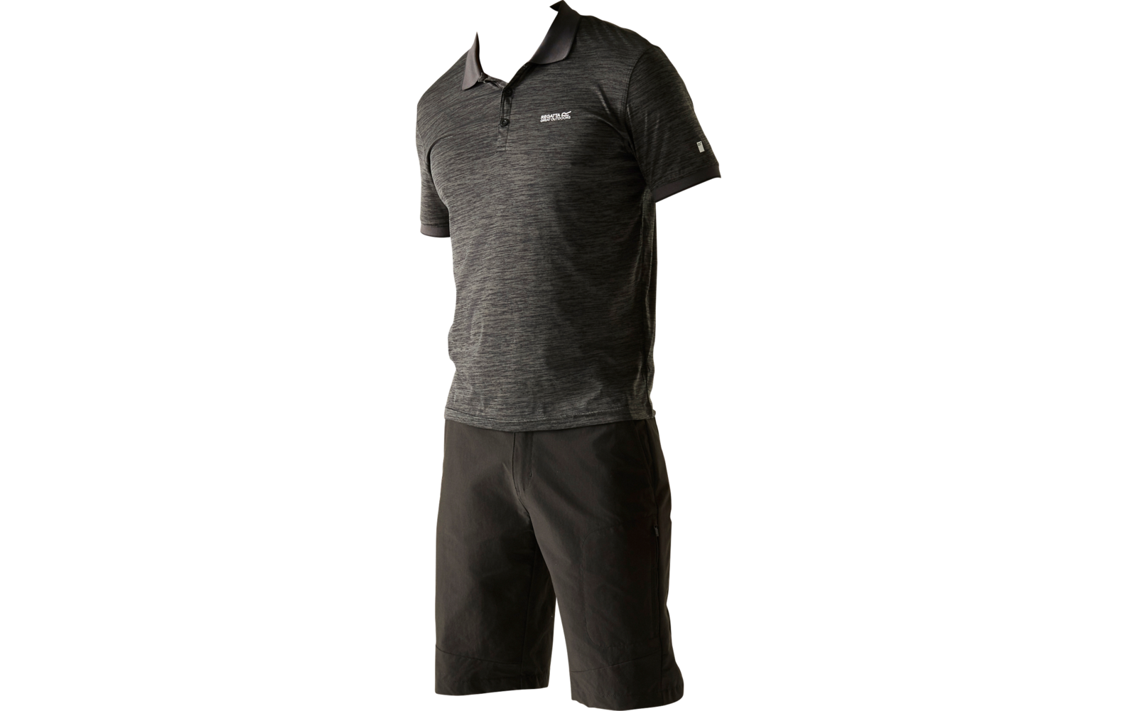 Person standing slightly turned on a light background, wearing a dark polo shirt, dark knee-length shorts, a black cap, white socks and black sneakers, looking to the side