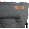 Gray padded seat/back cushion with small neck-roll pillow attached, two round brown leather tags at top right, visible metal frame at right and darker stains on the fabric
