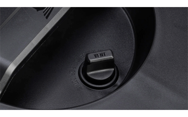 Nahaufnahme eines schwarzen Kunststoffdeckels mit runder Mulde und rundem Drehknopf in der Mitte, auf dem 'VENT' steht