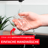 Main tenant un petit verre transparent sous l'eau courante du robinet ; bannière rouge avec les textes 'Gläser sind spülmaschinengeeignet' et 'EINFACHE HANDWÄSCHE' et une flèche