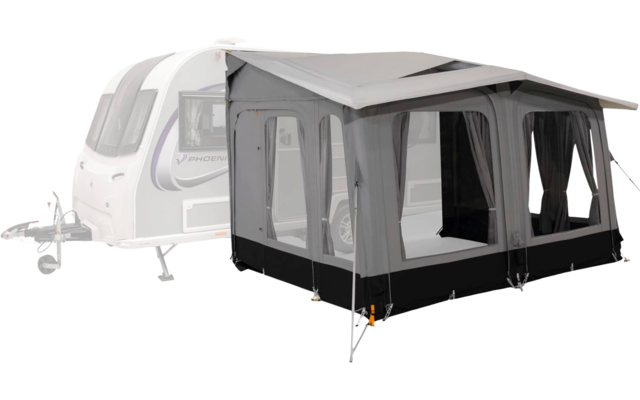 White caravan on the left with an attached gray awning/tent, large window panels, black lower skirt, guy lines and front support poles