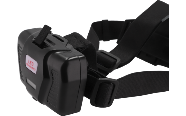 Schwarzes Kunststoffgerät mit verstellbaren Gurten und Schnallen; rechteckiges Frontgehäuse mit kleinem Aufkleber 'LED'