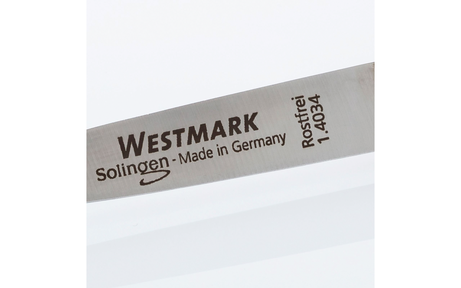 Metallklinge mit eingraviertem Text "WESTMARK", "Solingen - Made in Germany", "Rostfrei 1.4034"