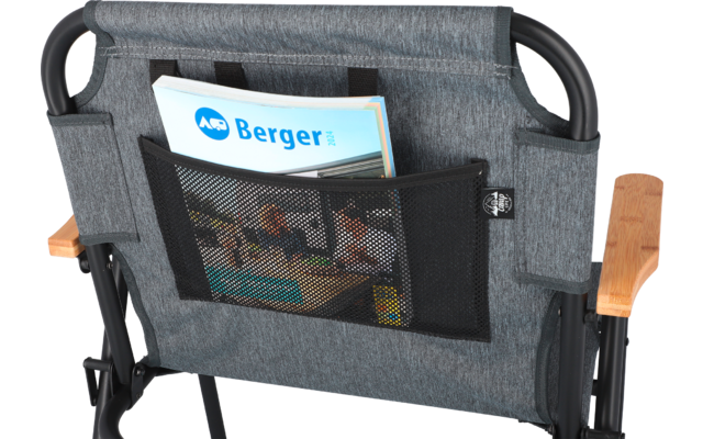Back of a chair with two pockets, one containing a magazine