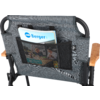Back of a chair with two pockets, one containing a magazine