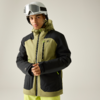 Person steht vor neutralem Hintergrund, trägt weißen Skihelm mit Skibrille, olivgrüne und schwarze Skijacke mit Kapuze und neonfarbigen Reißverschlüssen, hellgrüne Skihose, hält den Reißverschluss der Jacke mit beiden Händen