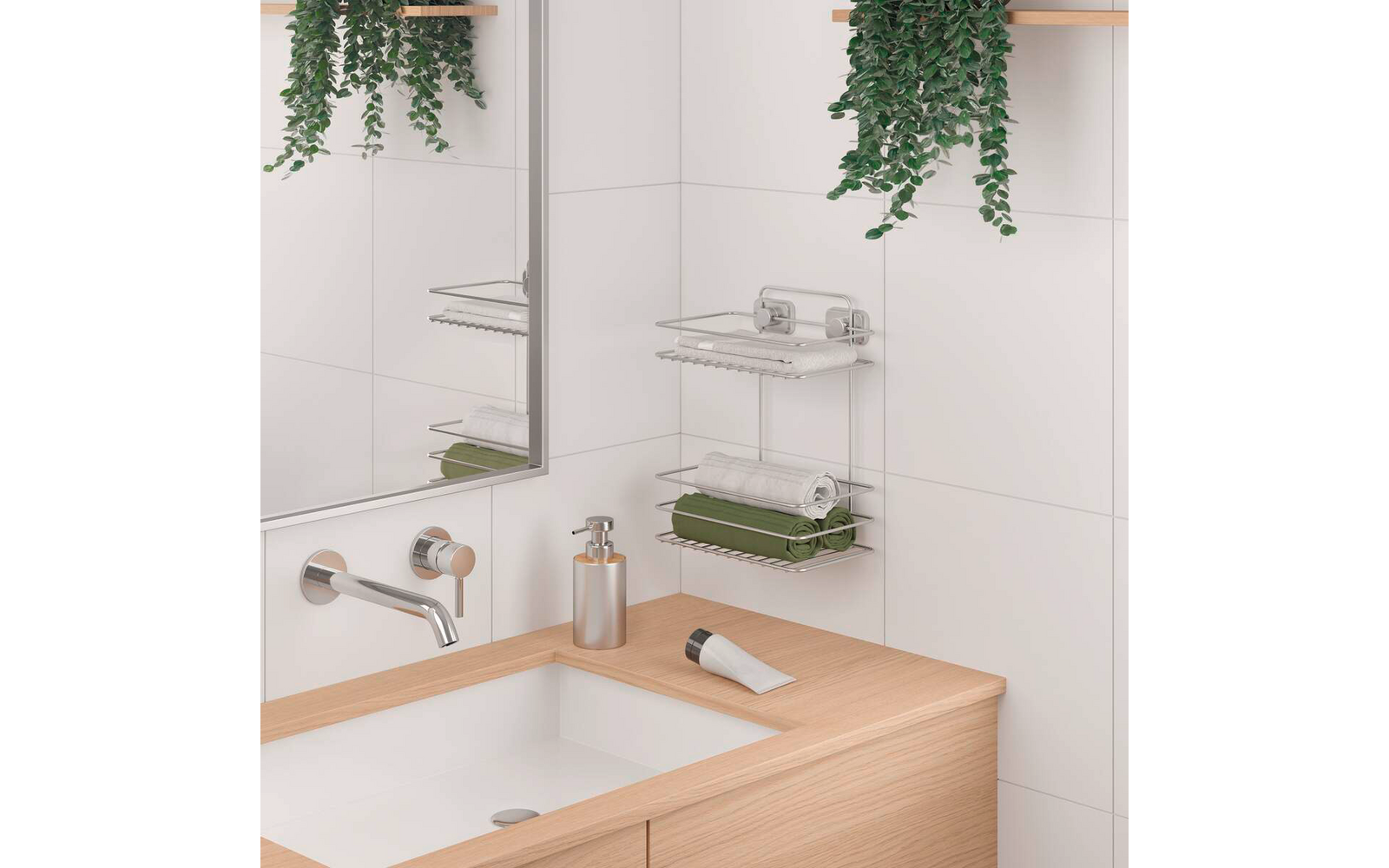 Weiß gefliestes Badezimmer mit Holzarbeitsplatte und integriertem weißen Waschbecken, Chrom-Wandarmatur, rechteckigem Spiegel, metallischem Wandregal mit aufgerollten Handtüchern (grün, weiß), Spenderflasche und Tube auf der Arbeitsplatte sowie hänge