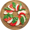 Ein Teller mit Mozzarella, Tomatenscheiben und frischem Basilikum