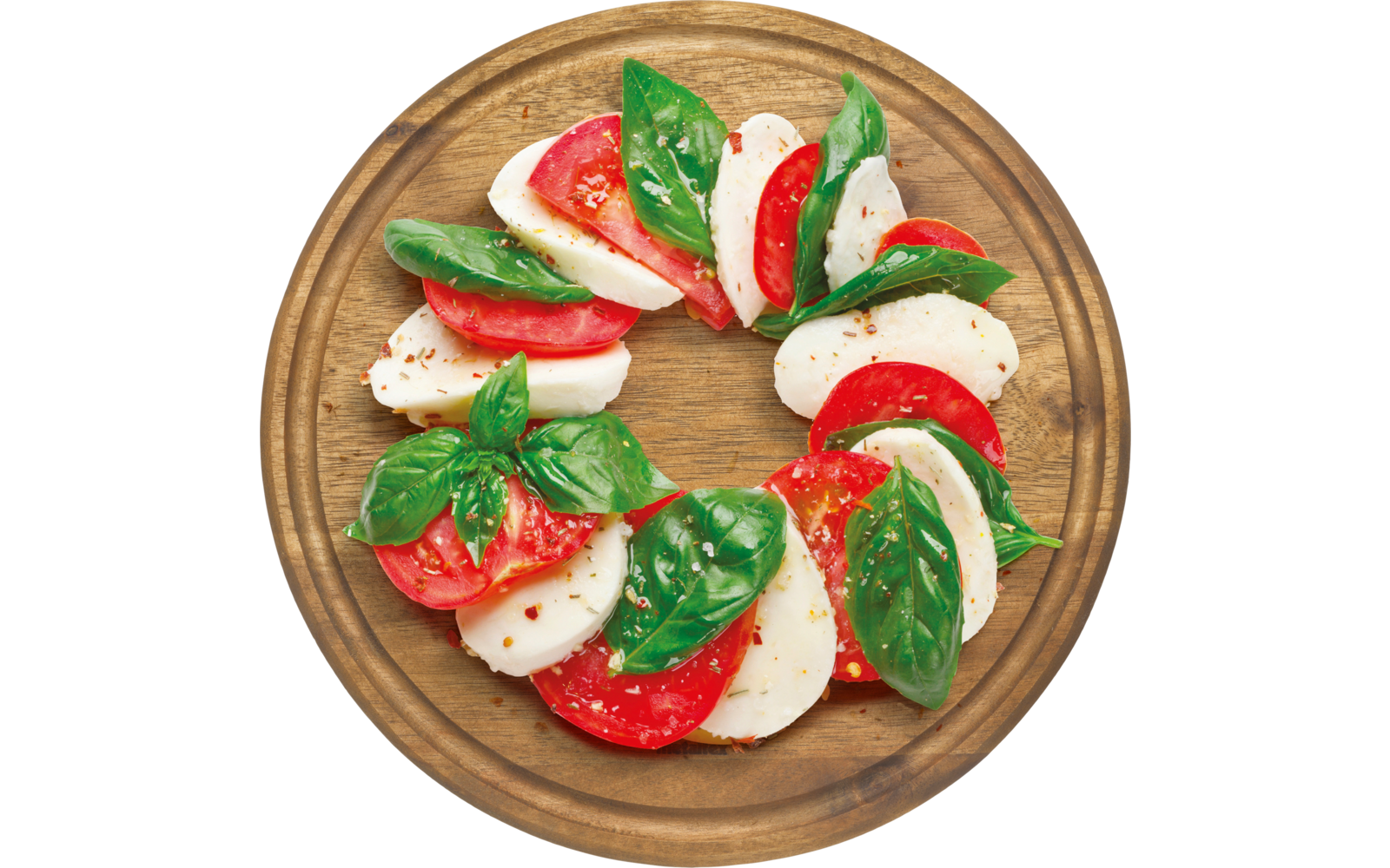 Ein Teller mit Mozzarella, Tomatenscheiben und frischem Basilikum