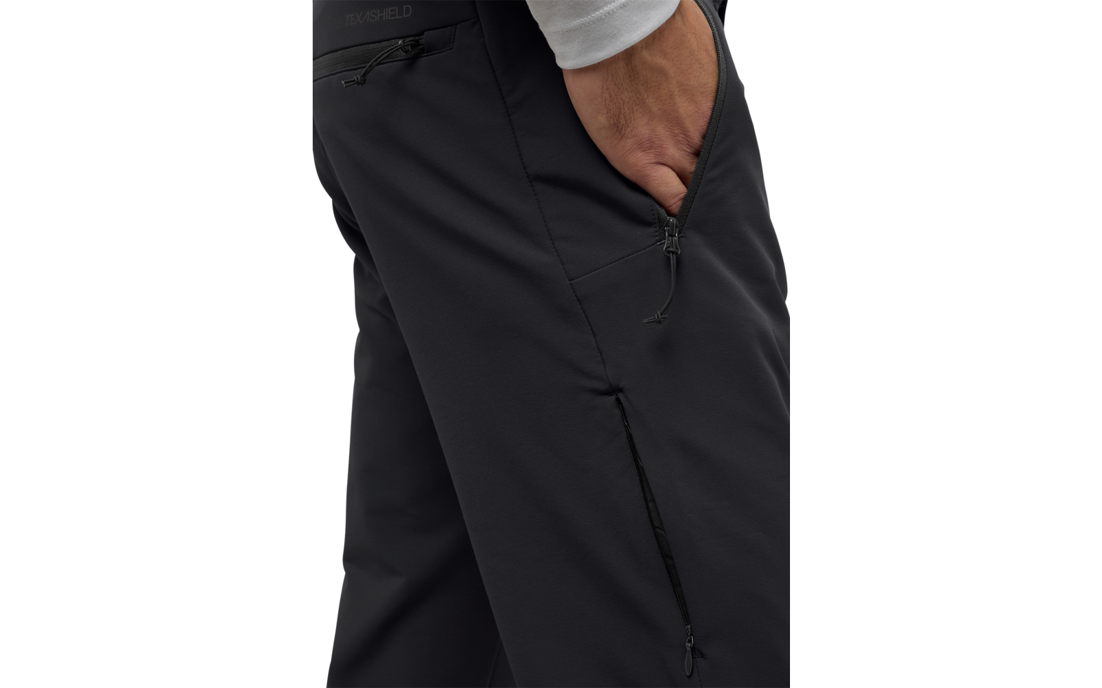 Hand steckt in der linken Hosentasche einer schwarzen Hose