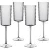 Four tall transparent stemmed glasses with cylindrical bowls, fine vertical ribs, long stems and round bases on a white background
