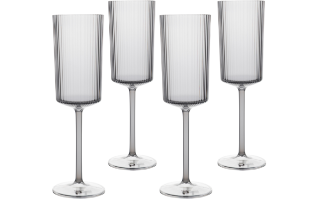 Four tall transparent stemmed glasses with cylindrical bowls, fine vertical ribs, long stems and round bases on a white background