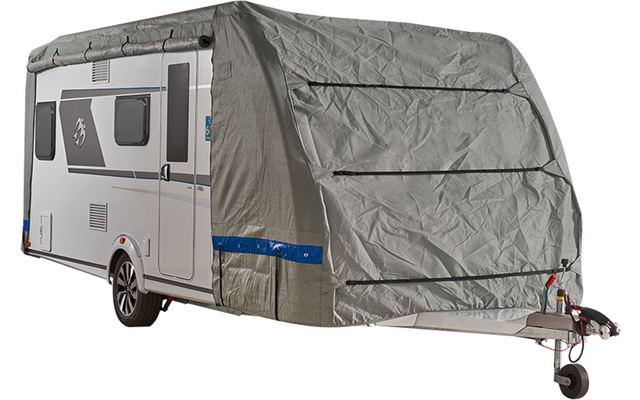 White caravan with a grey fabric covering the front; side windows, one wheel and tow hitch visible