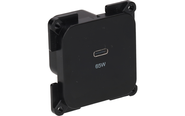 Boîtier plastique noir carré aux coins arrondis avec quatre pattes de fixation aux angles ; port USB-C centré et inscription '65W' en dessous