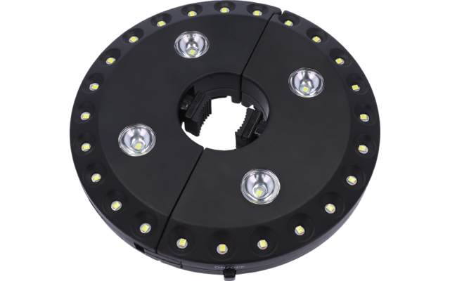 Schwarze runde Leuchte, in zwei Hälften geteilt, zentraler runder Ausschnitt, ringförmiger Rand mit vielen kleinen LEDs und vier größeren LED-Linsen innen