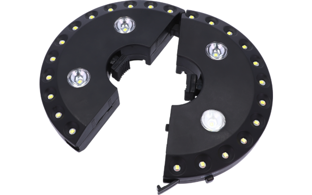 Schwarzes, ringförmiges Kunststoffgehäuse in zwei getrennten Segmenten, kleine gelblich leuchtende LEDs entlang des Außenrands, vier größere weiße LED-Module, innen sichtbare Aussparungen und ein kurzes Kabel am Rand