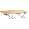 Light rectangular wooden tabletop with two folding gray metal legs underneath; two blue arrows indicate the direction of movement