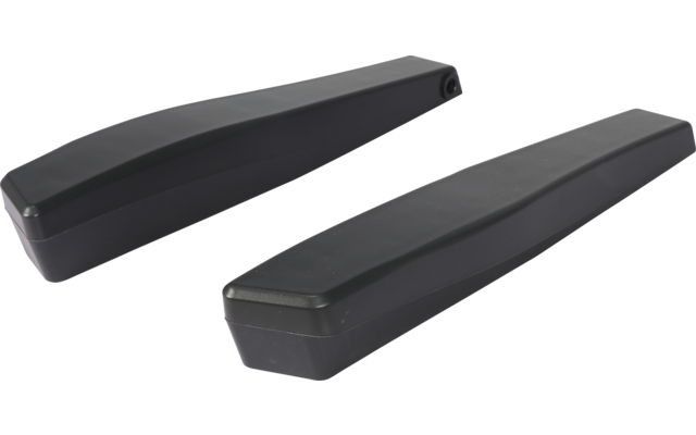 Dos objetos rectangulares alargados negros con bordes biselados sobre fondo blanco, uno junto al otro